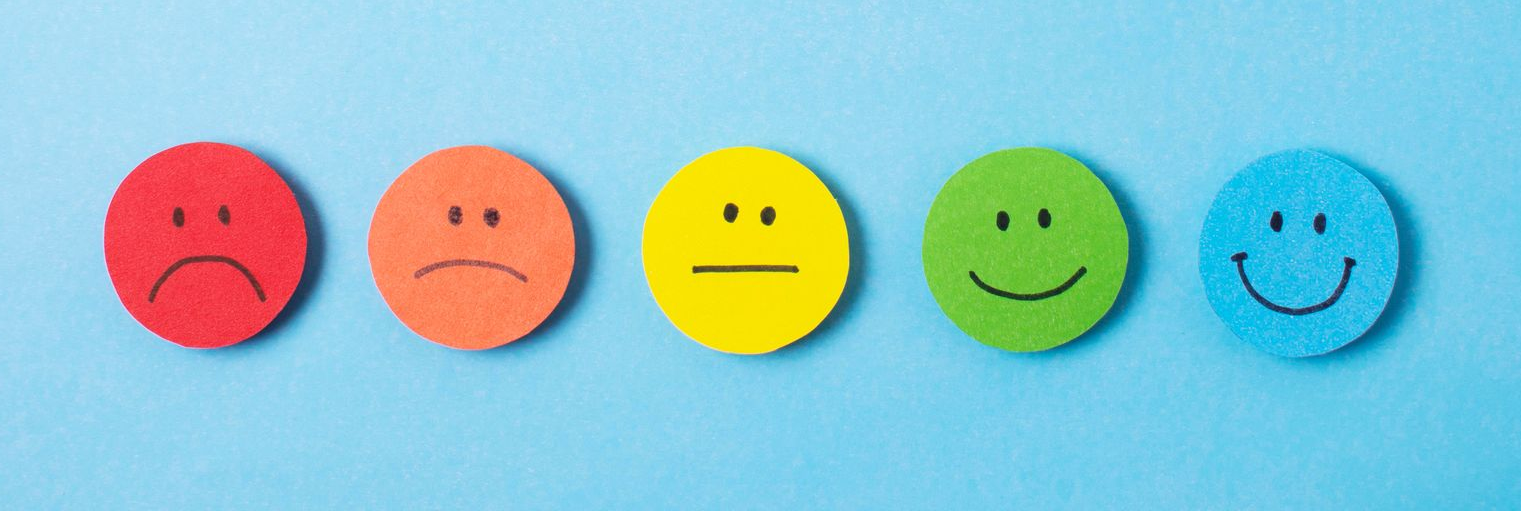 Five colored smiley face circles on a blue background, ranging from sad to happy.
