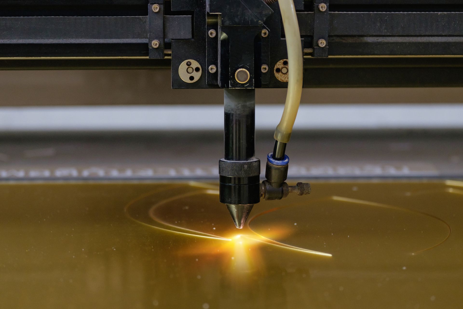 Close-up of a laser cutting machine processing plastic material.