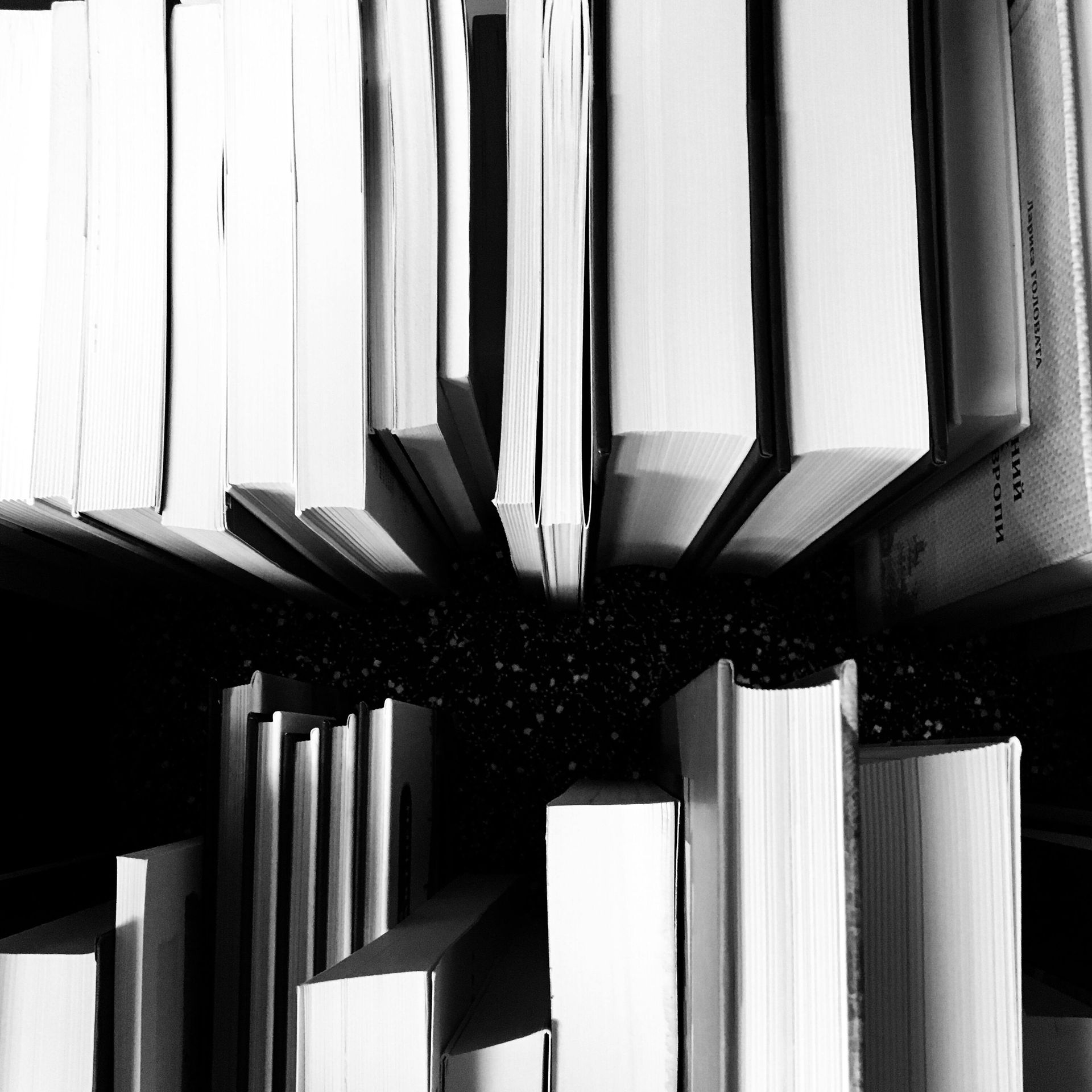 A black and white photo of a stack of books
