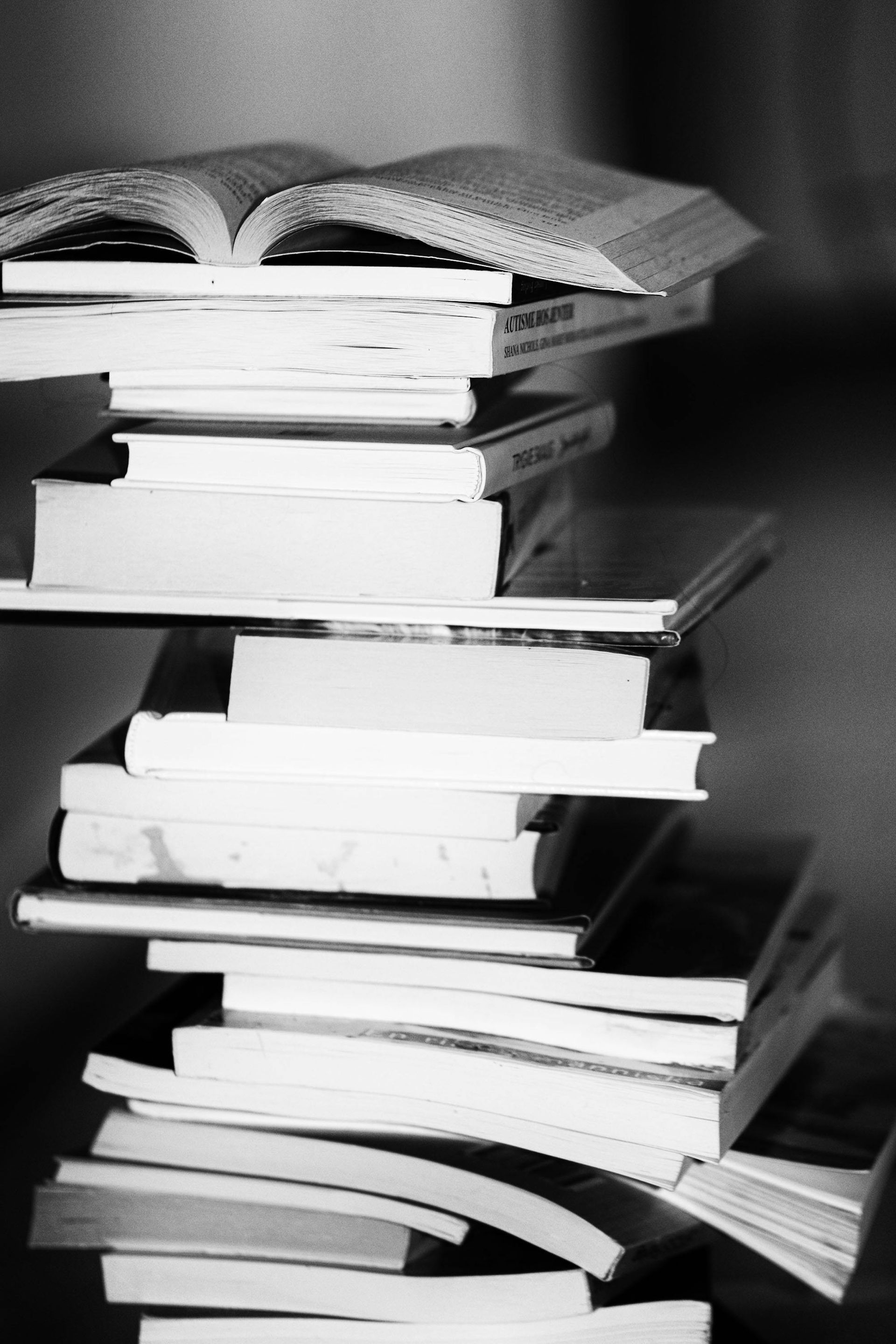 A black and white photo of a stack of books