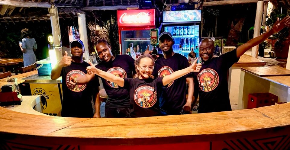 Small white kitchen with appliances: refrigerator, microwave, coffee maker, toaster, and sink.