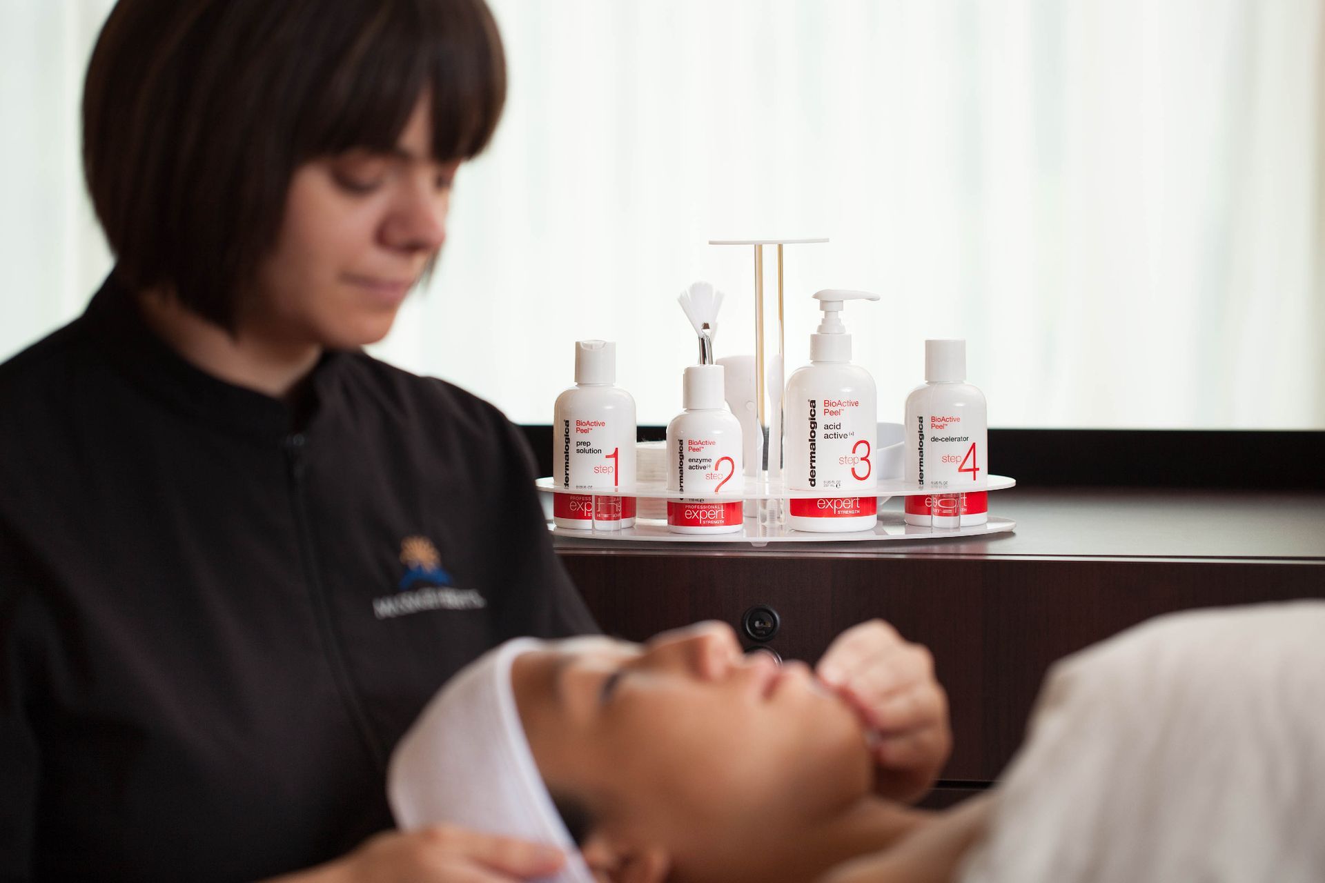 Massage Heights esthetician preparing Dermalogica skincare products for a facial