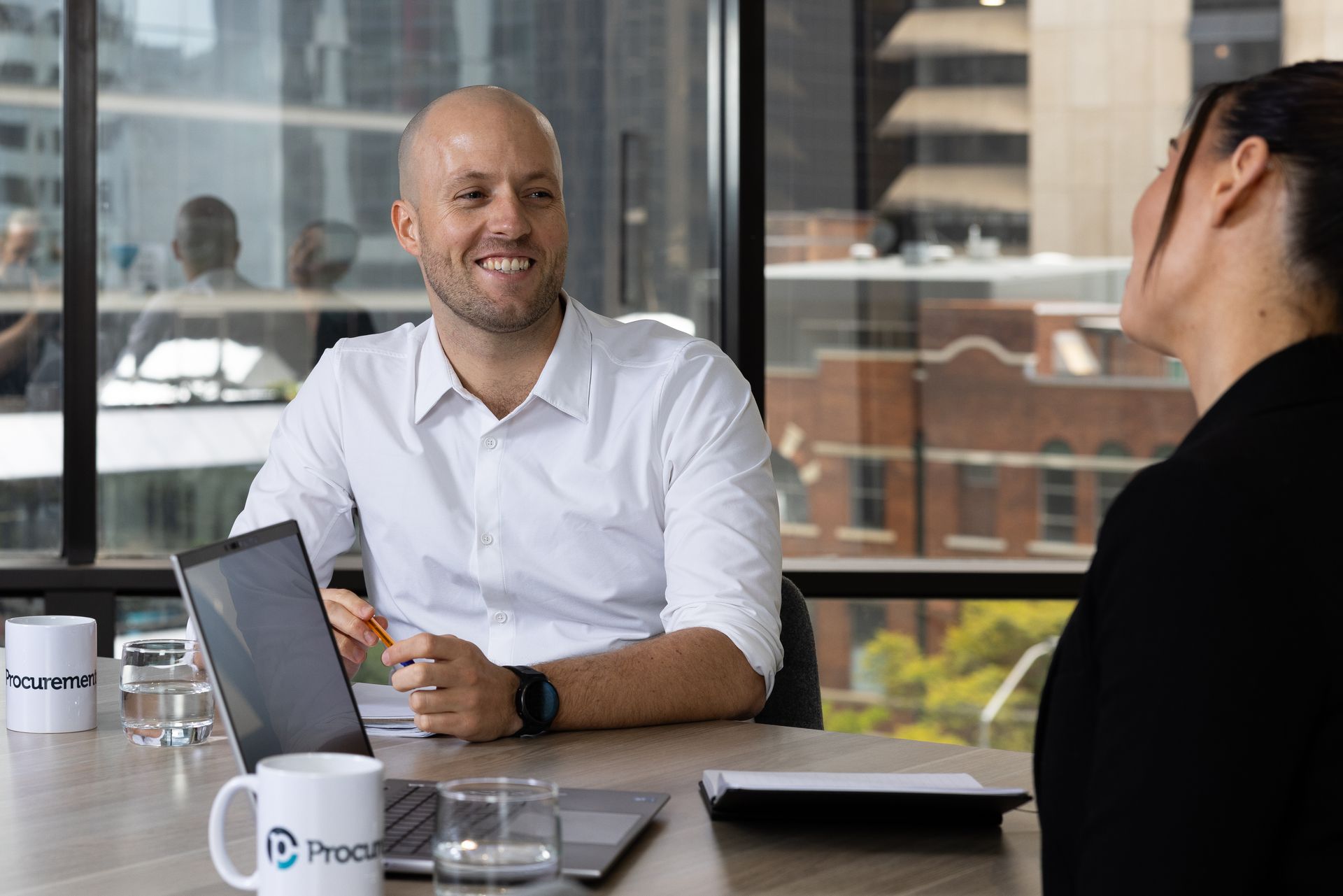 A man and a woman are sitting at a table having a conversation.