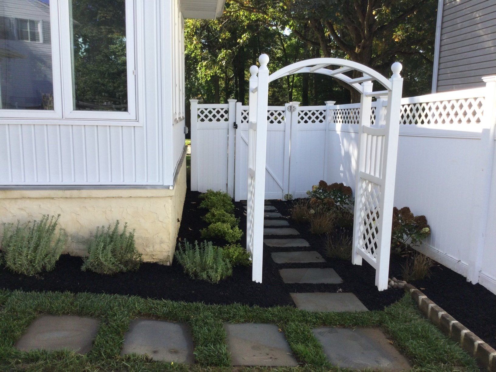 White Backyard Fence With Arch — New Castle, DE — Ayala Landscaping