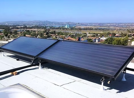 Person installing solar panels with a drill, wearing gloves, outdoors.