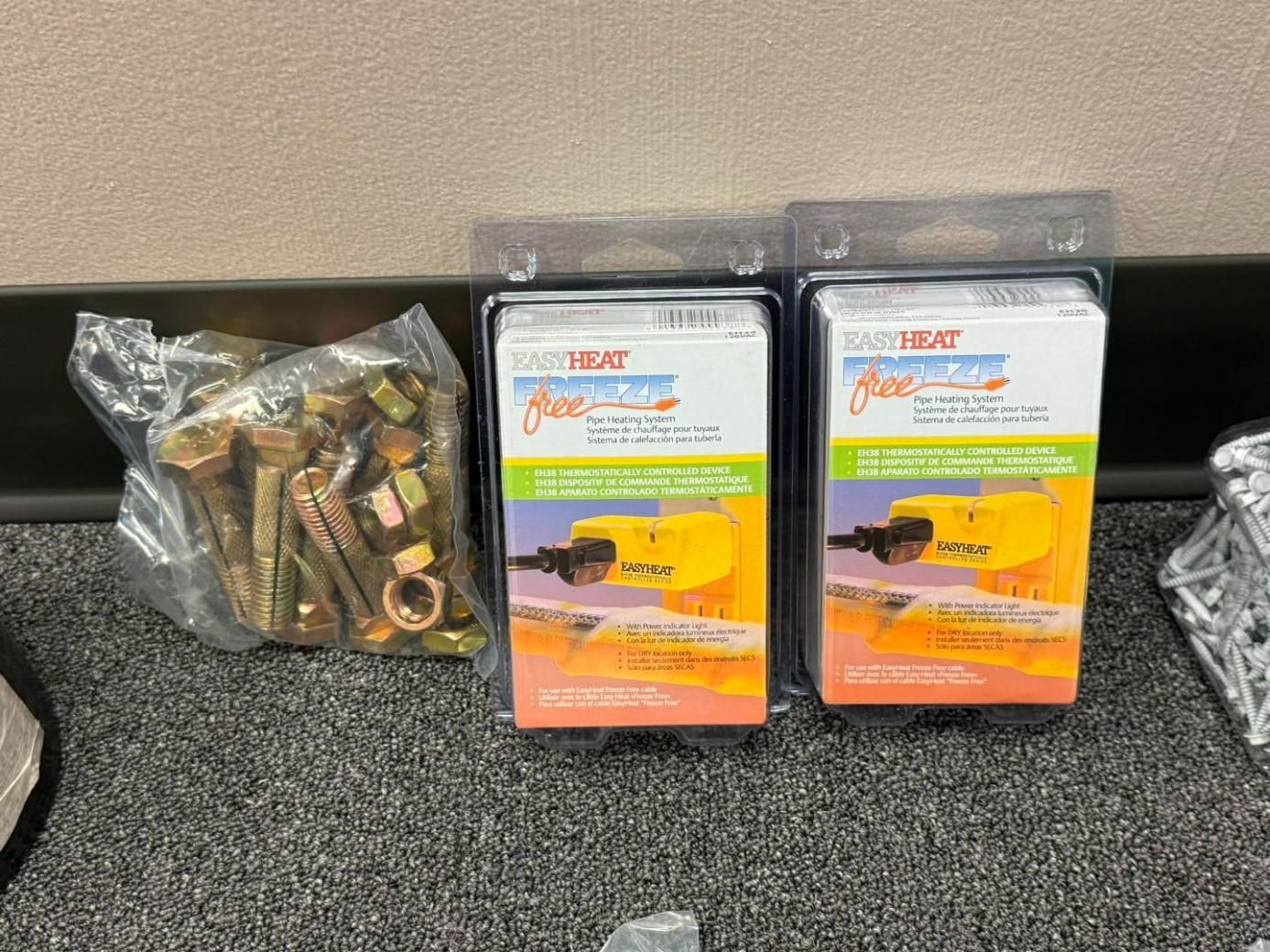 Hardware store display with bolts, nuts, and two packages of Heatwave freeze protection.