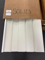 White corrugated metal panel in a cardboard box labeled 