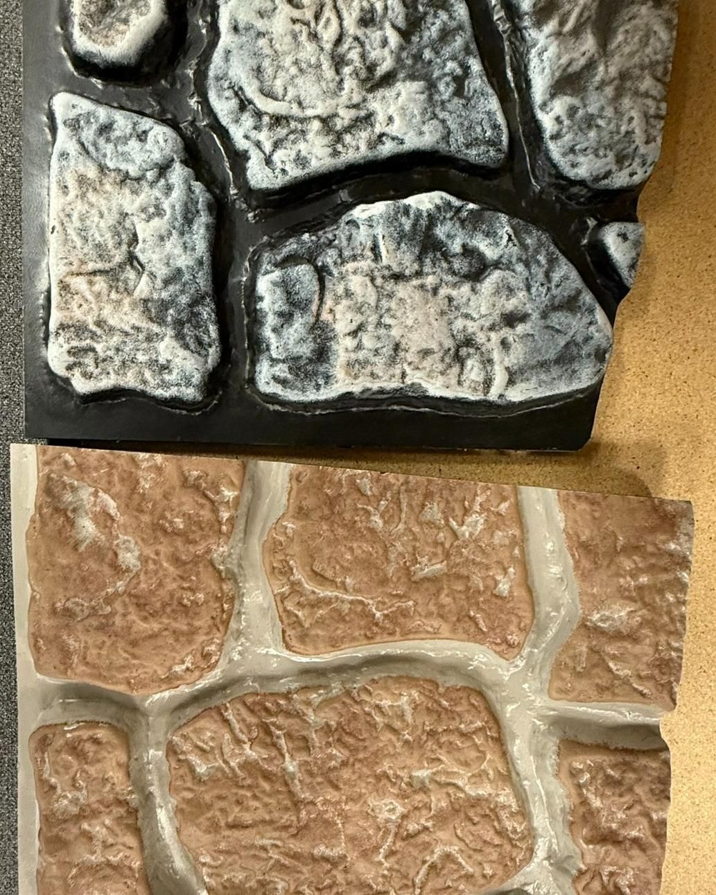 Two stone veneer panels, one gray and one reddish-brown.