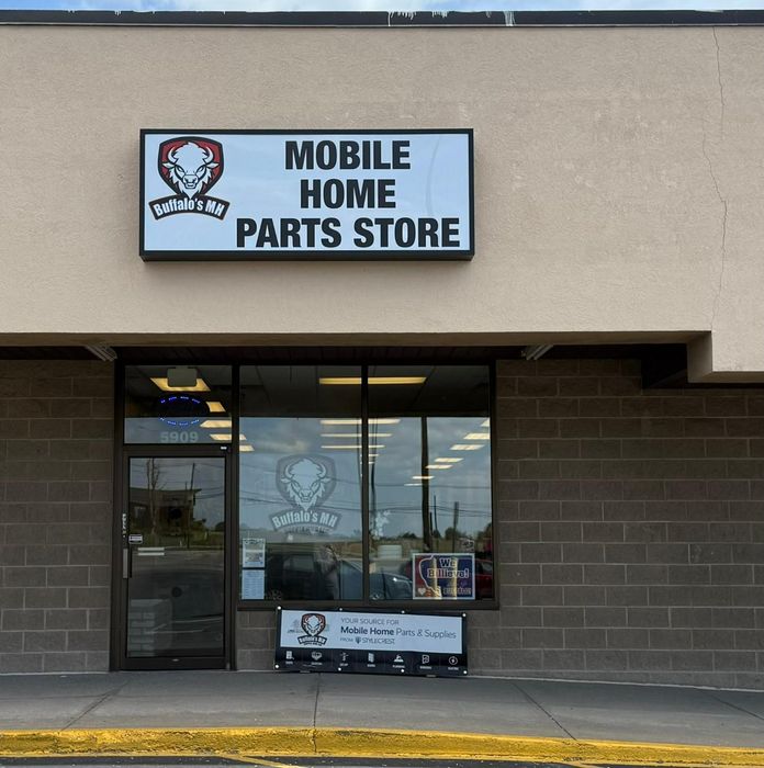 Mobile Home Parts Store storefront with sign, logo, and brick facade.