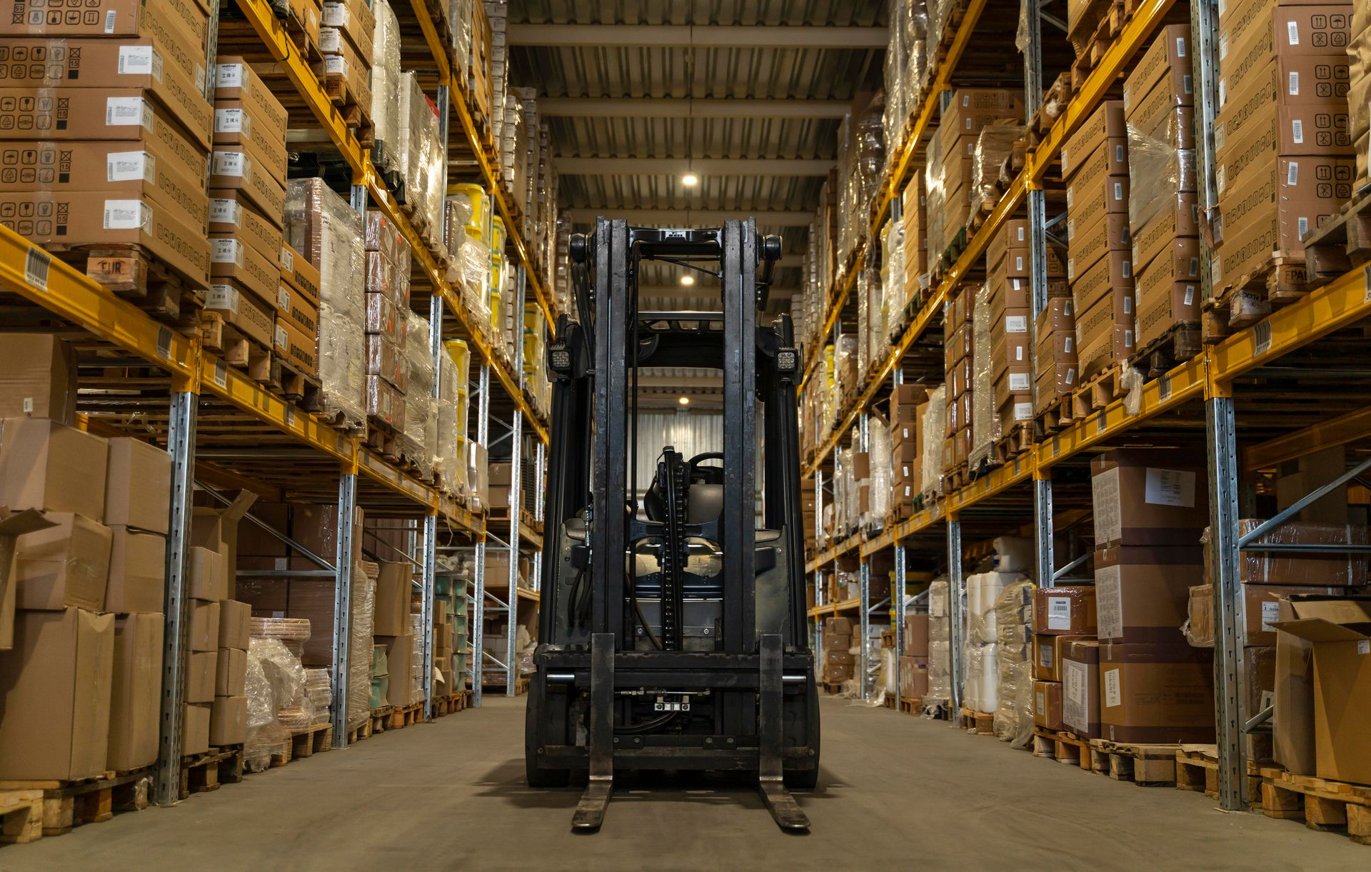 Warehouse with a forklift ready to move stock into locations