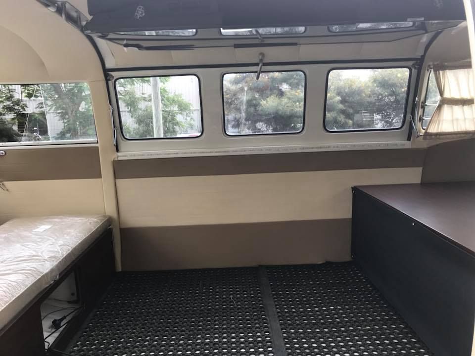 The Inside of a Camper Van With a Mattress and a Table — Currumbin Trimmers In Burleigh Heads, QLD