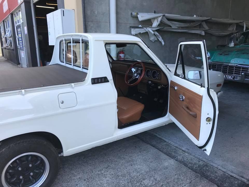A White Truck With Its Doors Open is Parked in Front of a Building — Currumbin Trimmers In Murwillumbah, NSW