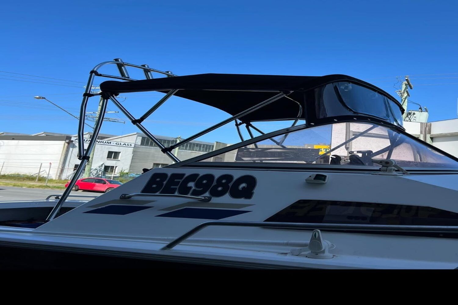 A White Boat With A Black Canopy On Top Of It — Currumbin Trimmers In Currumbin Waters, QLD
