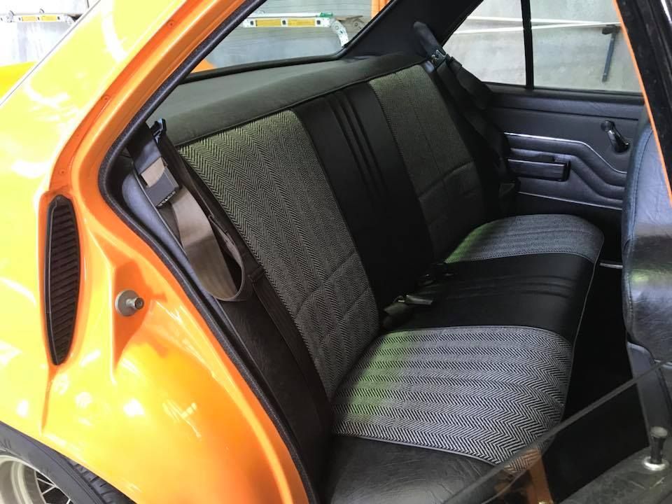 The Back Seat of an Orange Car With Black Seats — Currumbin Trimmers In Kingscliff, NSW