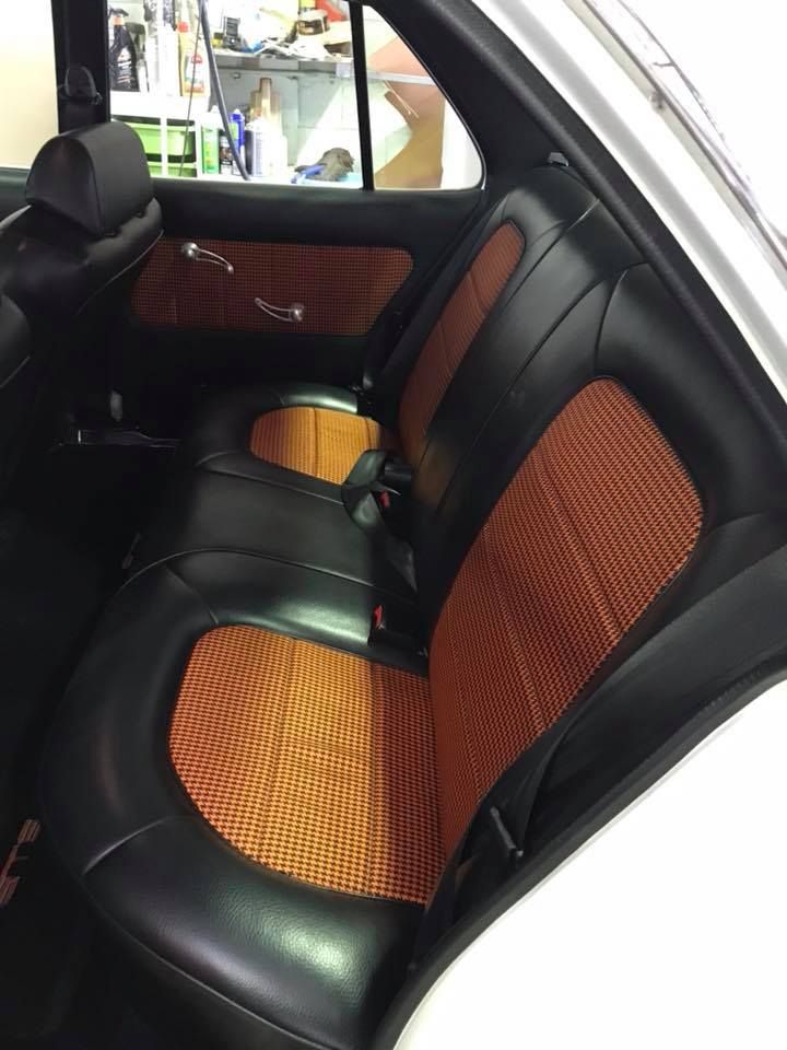 The Back Seat of a White Car With Black and Orange Seats — Currumbin Trimmers In Kingscliff, NSW