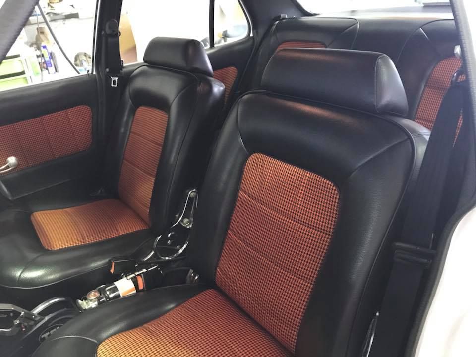 The Inside of a Car With Black and Orange Seats — Currumbin Trimmers In Kingscliff, NSW