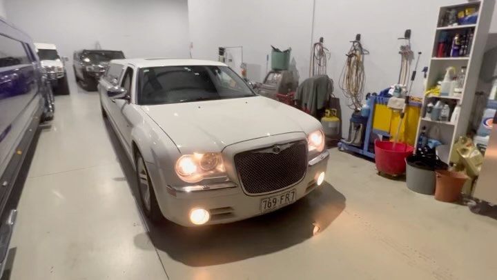 A White Limousine Is Parked In A Garage — Currumbin Trimmers  In Currumbin Waters, QLD