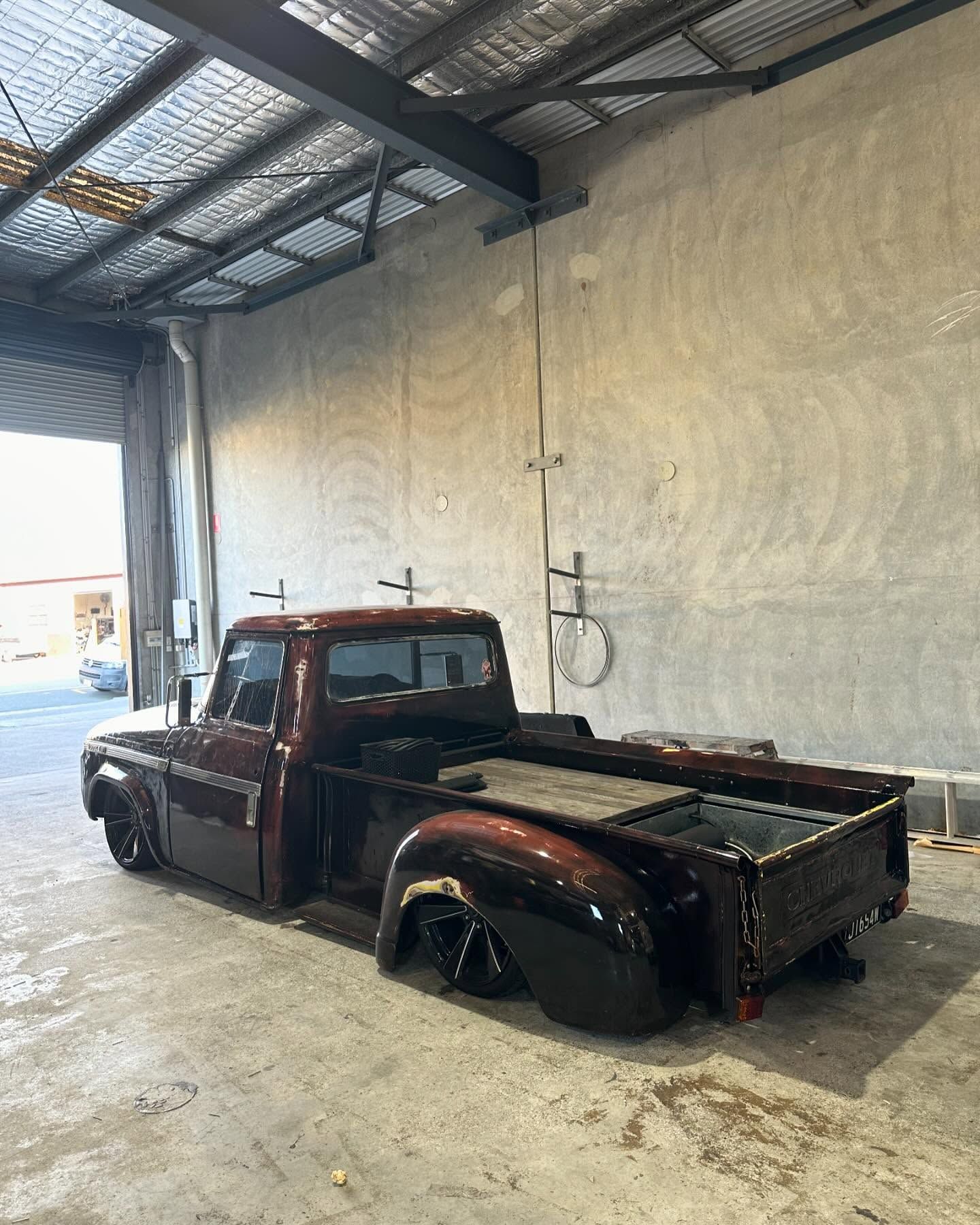 A Brown Truck is Parked in a Garage Next to a Wall — Currumbin Trimmers In Currumbin Waters, QLD