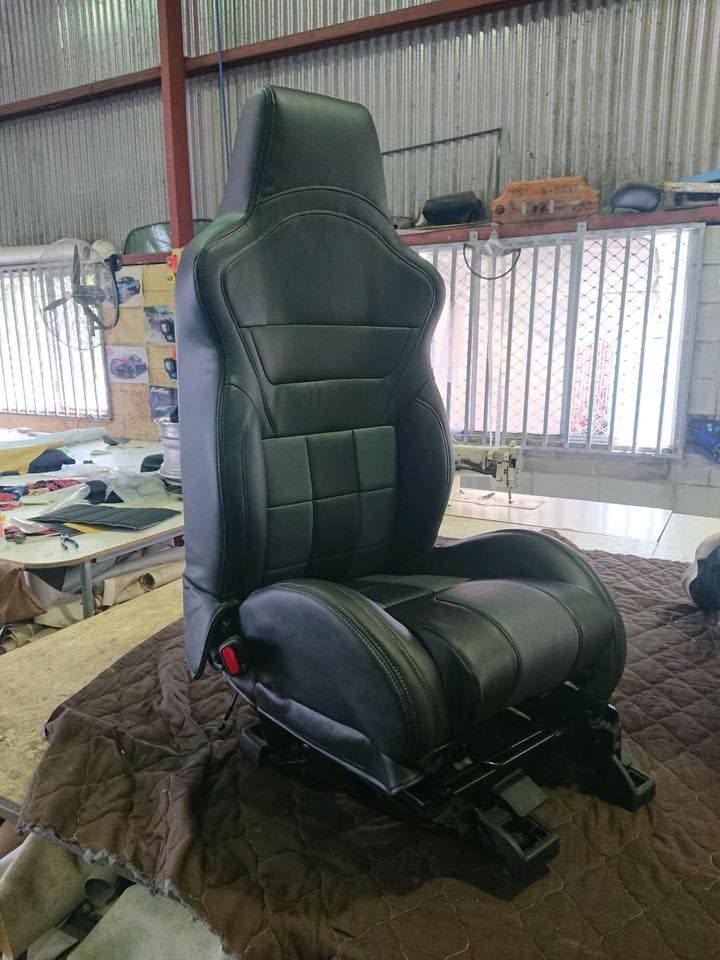 A Black Leather Seat is Sitting on Top of a Blanket in a Room — Currumbin Trimmers In Kingscliff, NSW