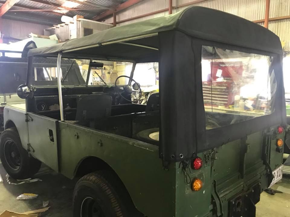 A Green Land Rover is Parked in a Garage — Currumbin Trimmers In Kingscliff, NSW