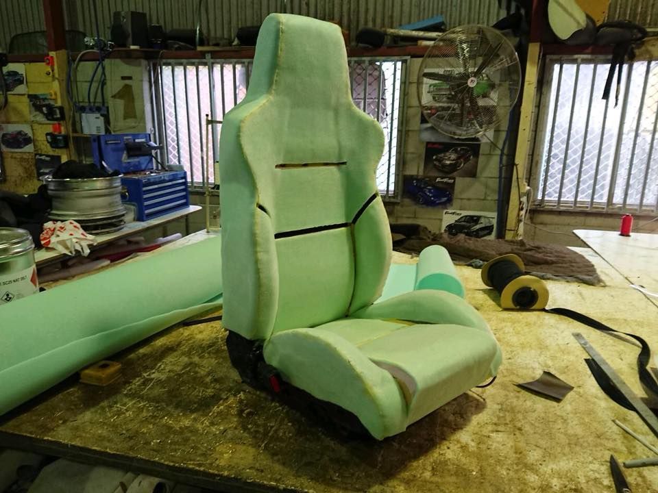A Car Seat is Sitting on Top of a Wooden Table — Currumbin Trimmers In Tweed Heads, NSW