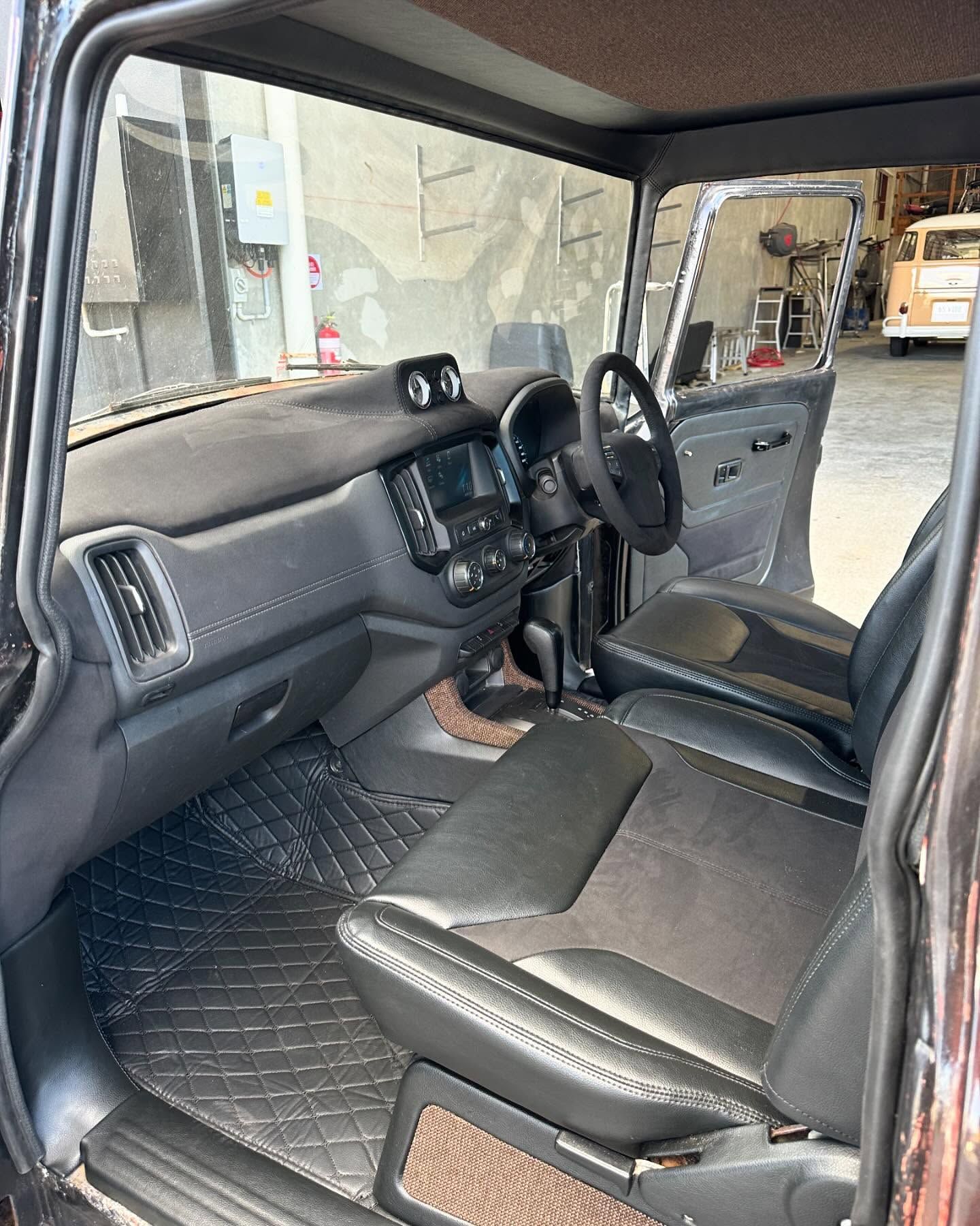 The Inside of a Car With the Door Open and a Steering Wheel — Currumbin Trimmers In Currumbin Waters, QLD