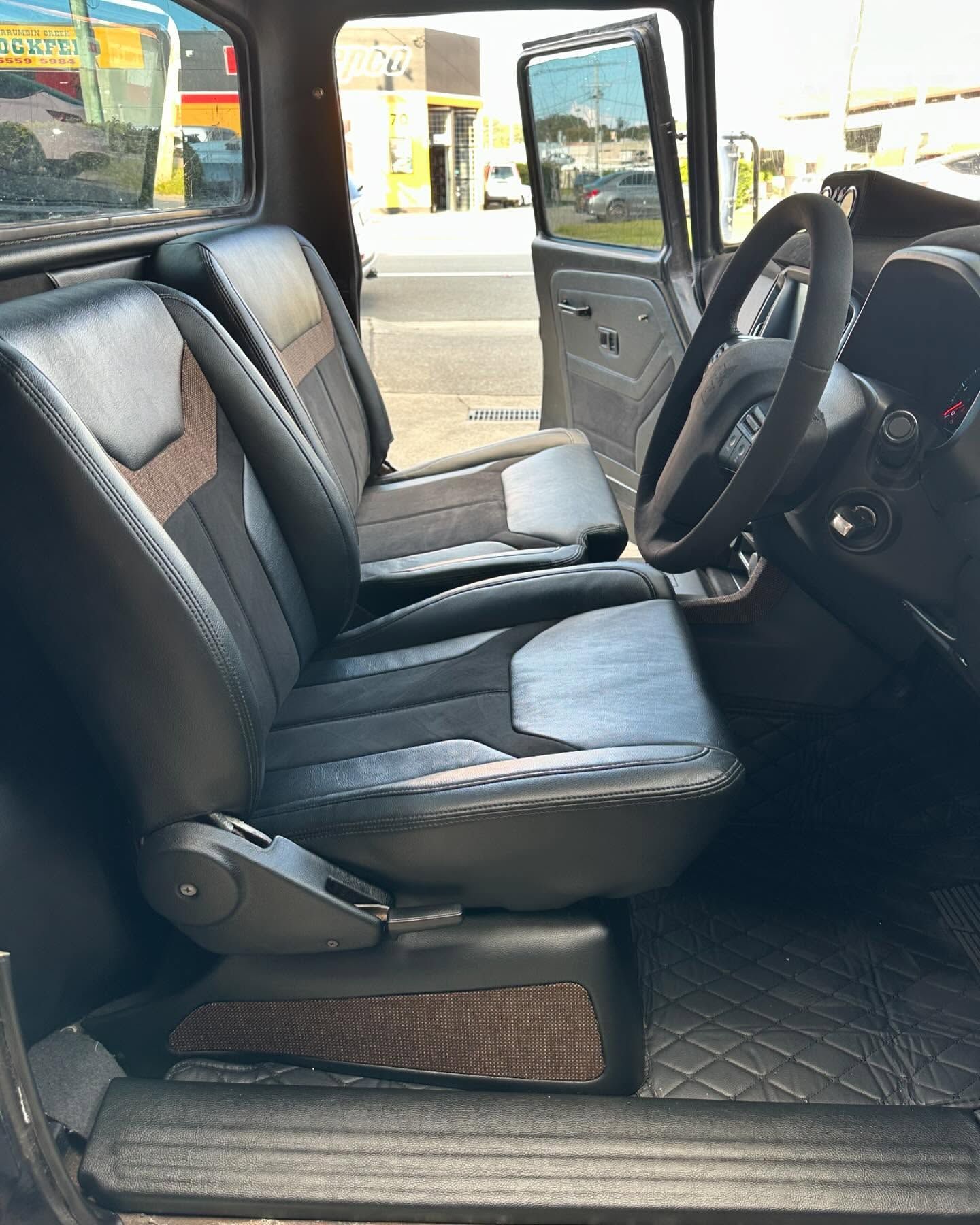 The Interior of a Truck With Black Leather Seats and a Steering Wheel — Currumbin Trimmers In Currumbin Waters, QLD