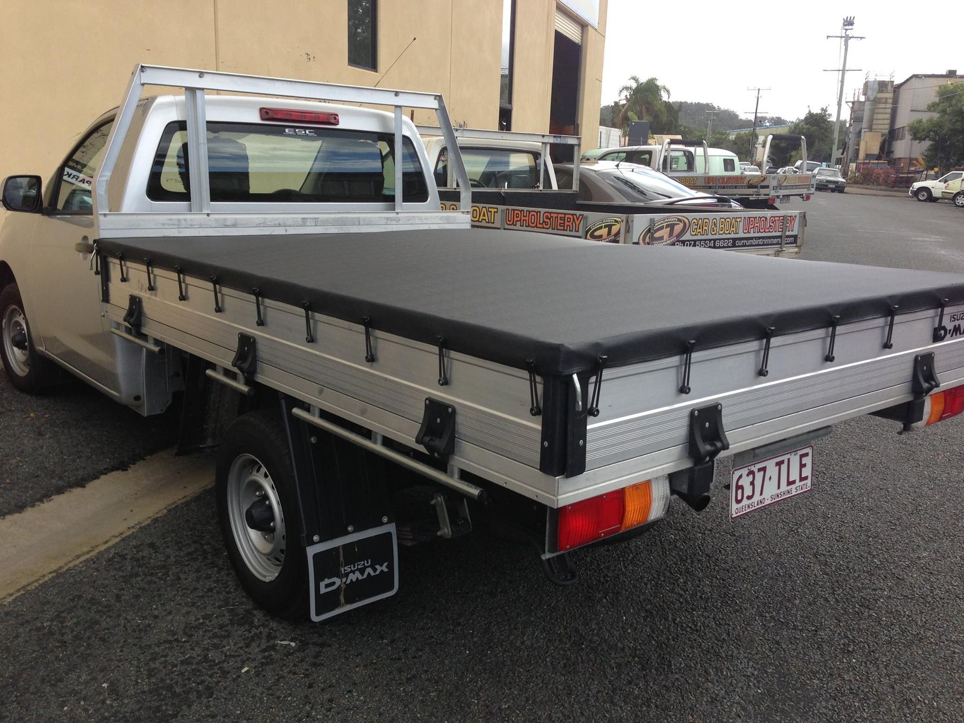A Silver Truck With a Black Tarp on the Bed is Parked in a Parking Lot — Currumbin Trimmers In Burleigh Heads, QLD