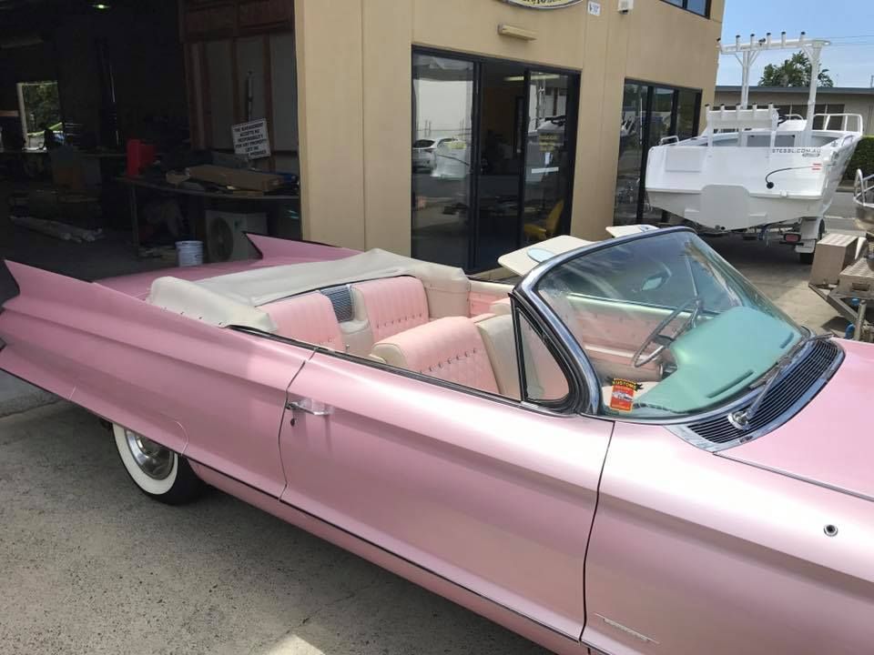 A Pink Convertible is Parked in Front of a Building — Currumbin Trimmers In Burleigh Heads, QLD