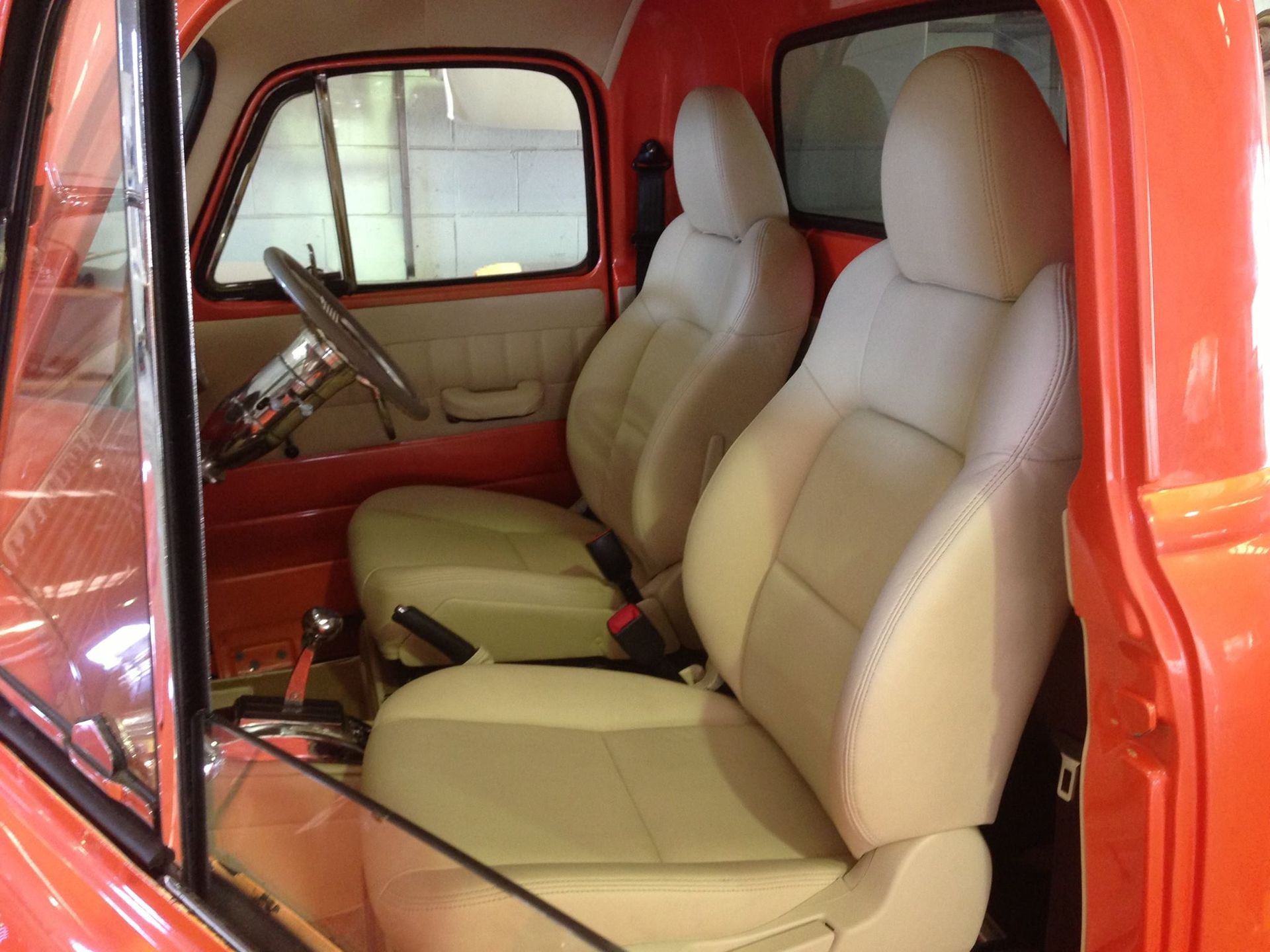 A Red Truck With White Leather Seats and a Steering Wheel — Currumbin Trimmers In Burleigh Heads, QLD