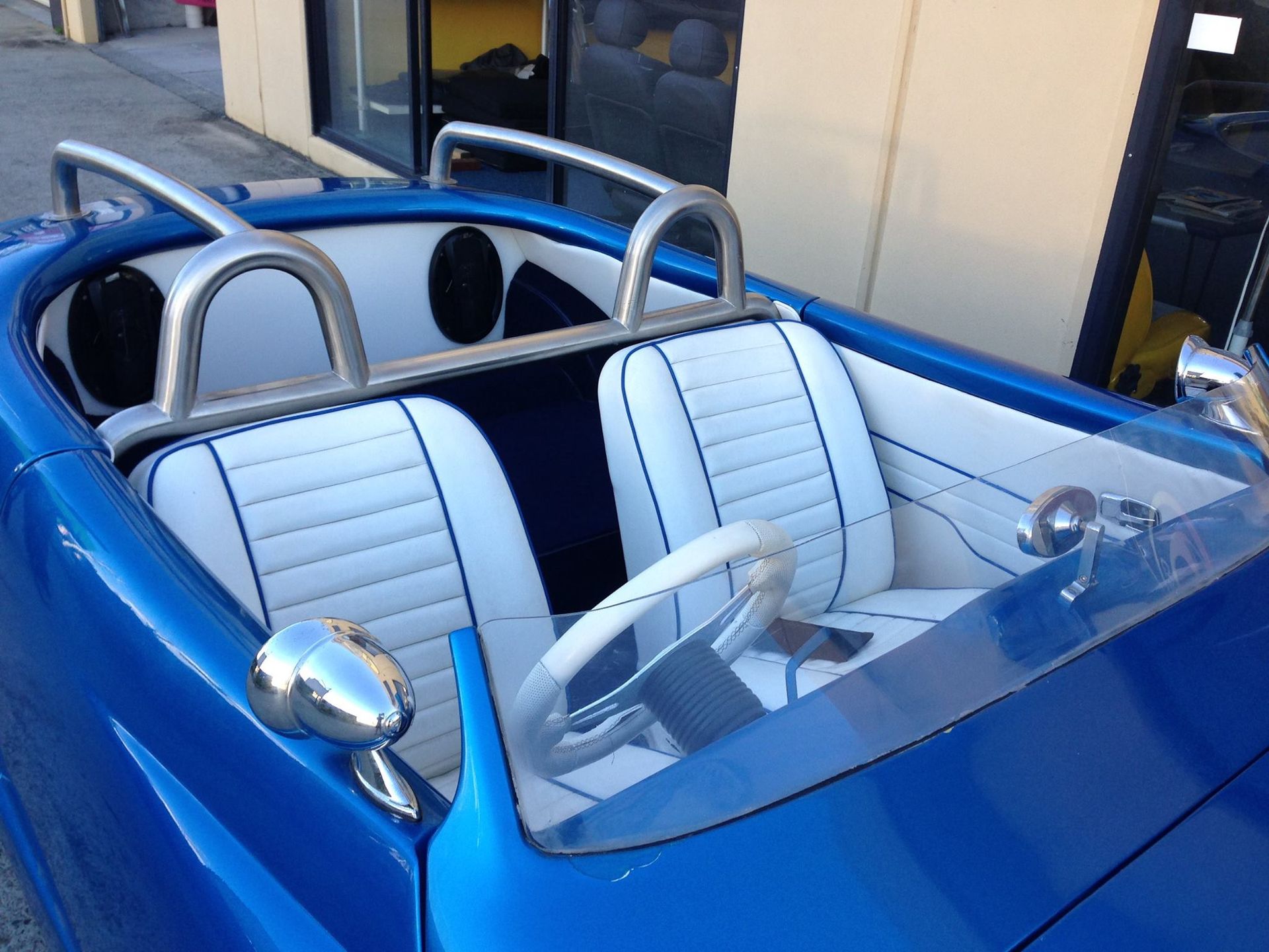 A Blue Car With White Seats and a Steering Wheel — Currumbin Trimmers In Murwillumbah, NSW