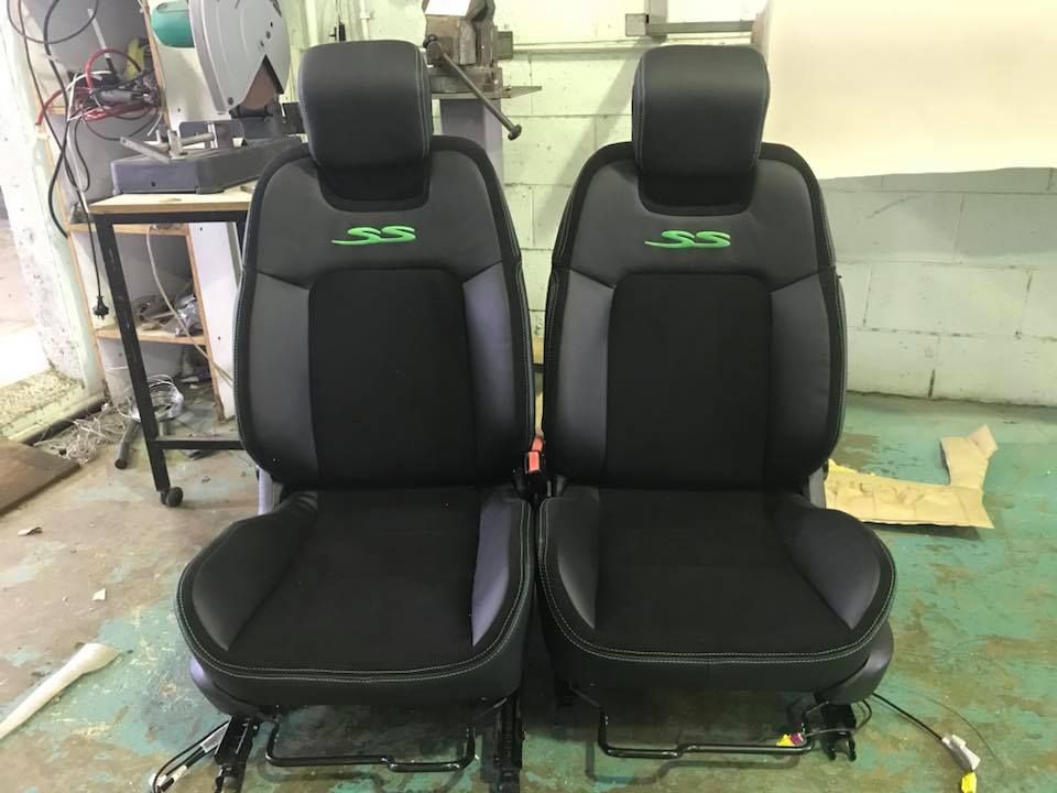 A Pair of Black Leather Seats Are Sitting Next to Each Other in a Room — Currumbin Trimmers In Burleigh Heads, QLD