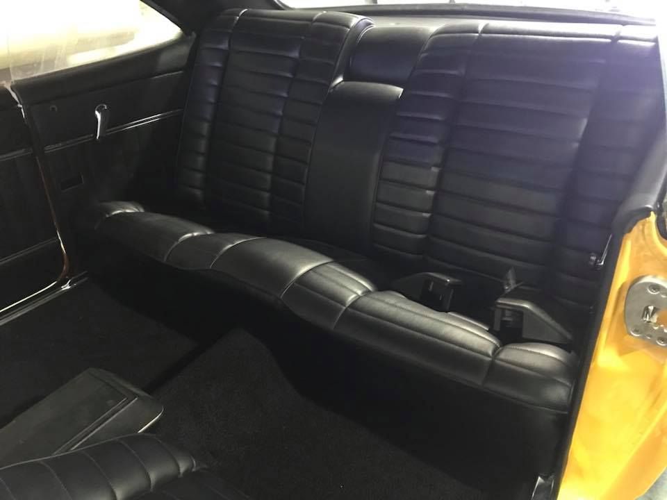 The Back Seat of a Yellow Car With Black Leather Seats — Currumbin Trimmers In Burleigh Heads, QLD