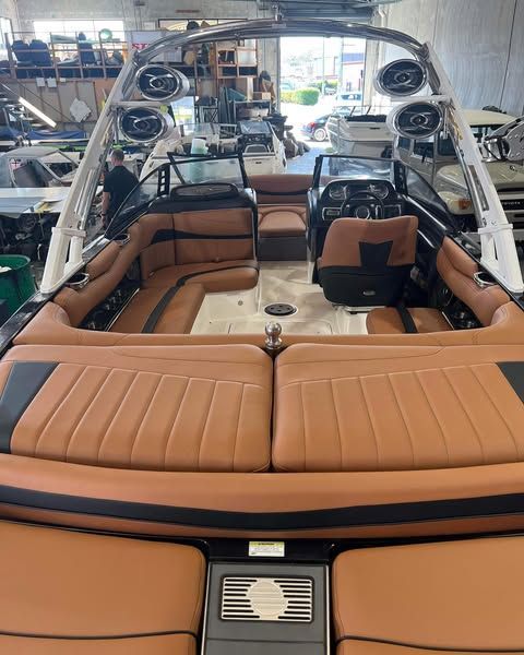 The Inside Of A Boat With Brown Leather Seats And Speakers — Currumbin Trimmers  In Currumbin Waters, QLD