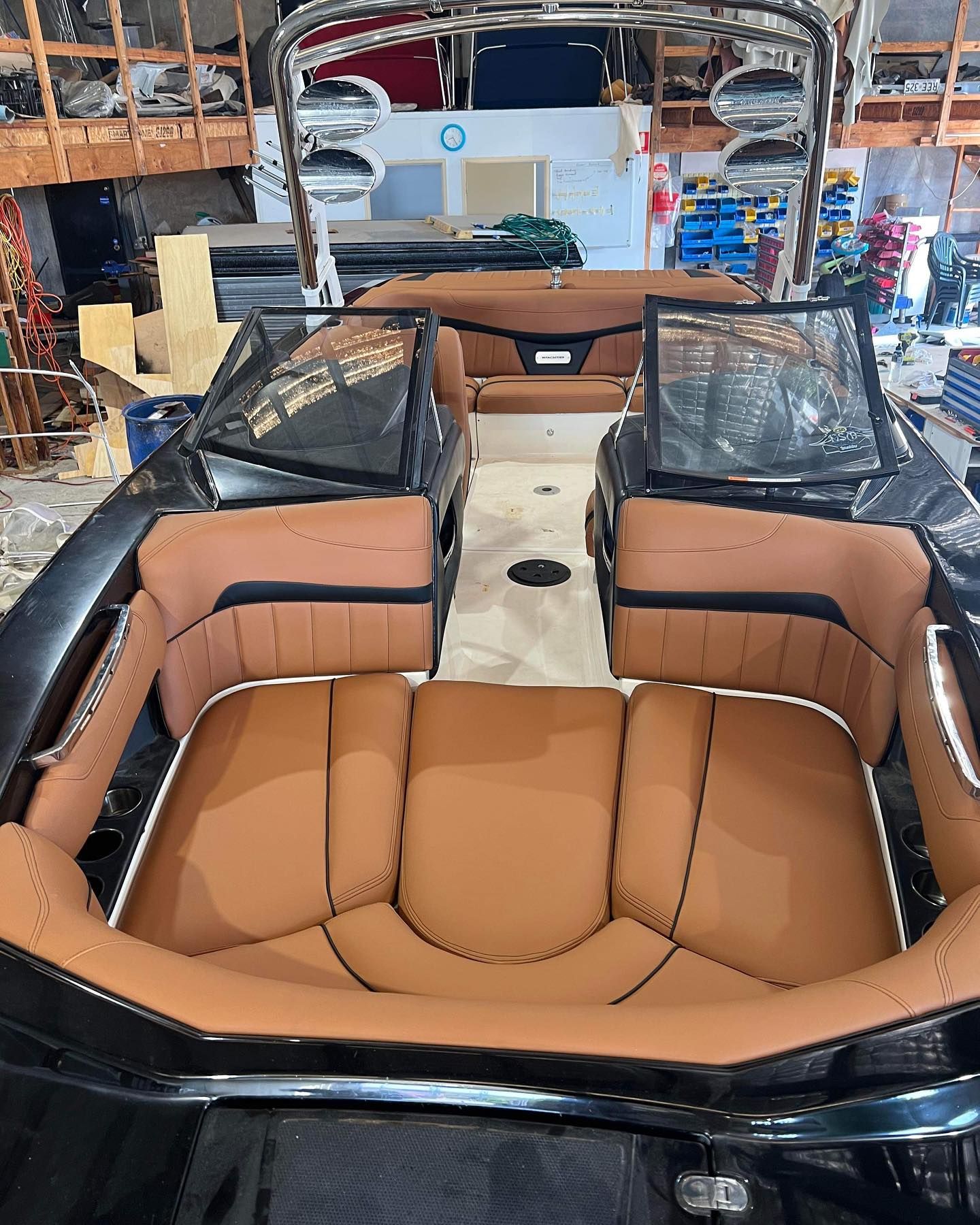 A Boat With Brown Seats is Sitting in a Warehouse — Currumbin Trimmers In Byron Bay, NSW