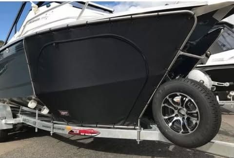 A Black And White Boat Is Parked On A Trailer — Currumbin Trimmers  In Currumbin Waters, QLD