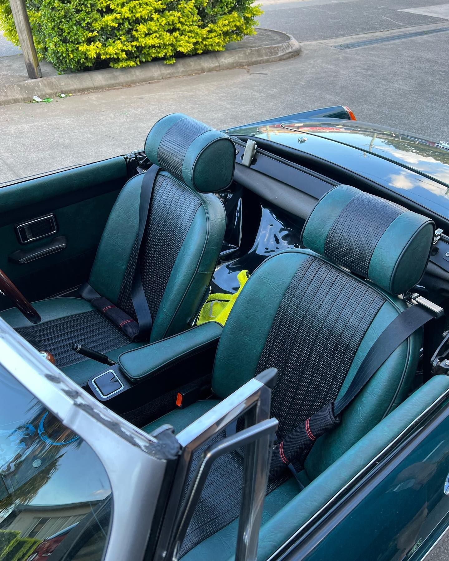 A Convertible Car With Green Seats is Parked on the Side of the Road — Currumbin Trimmers In Tweed Heads, NSW