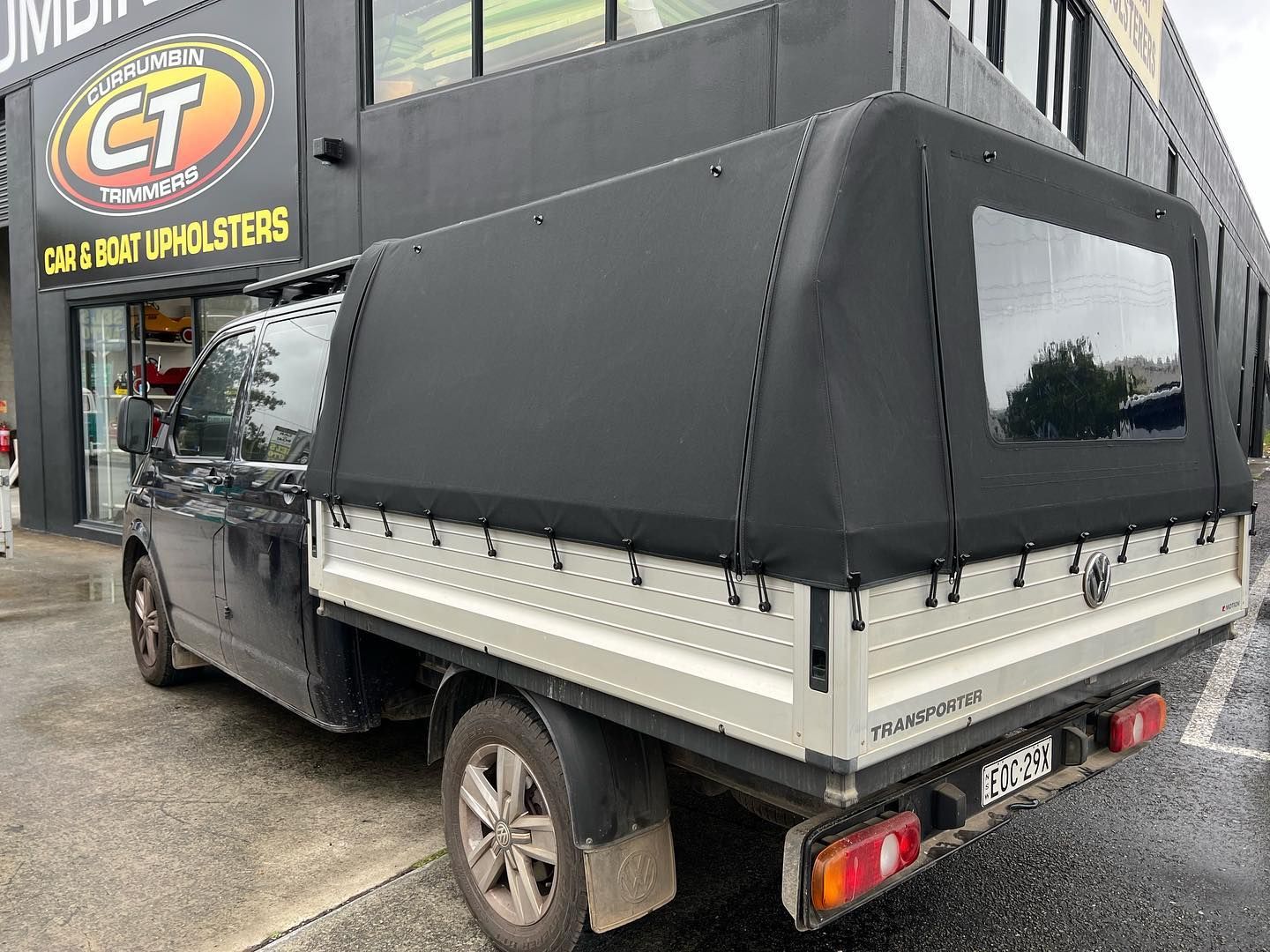 A Truck With a Canopy on Top of It is Parked in Front of a Building — Currumbin Trimmers In Tweed Heads, NSW