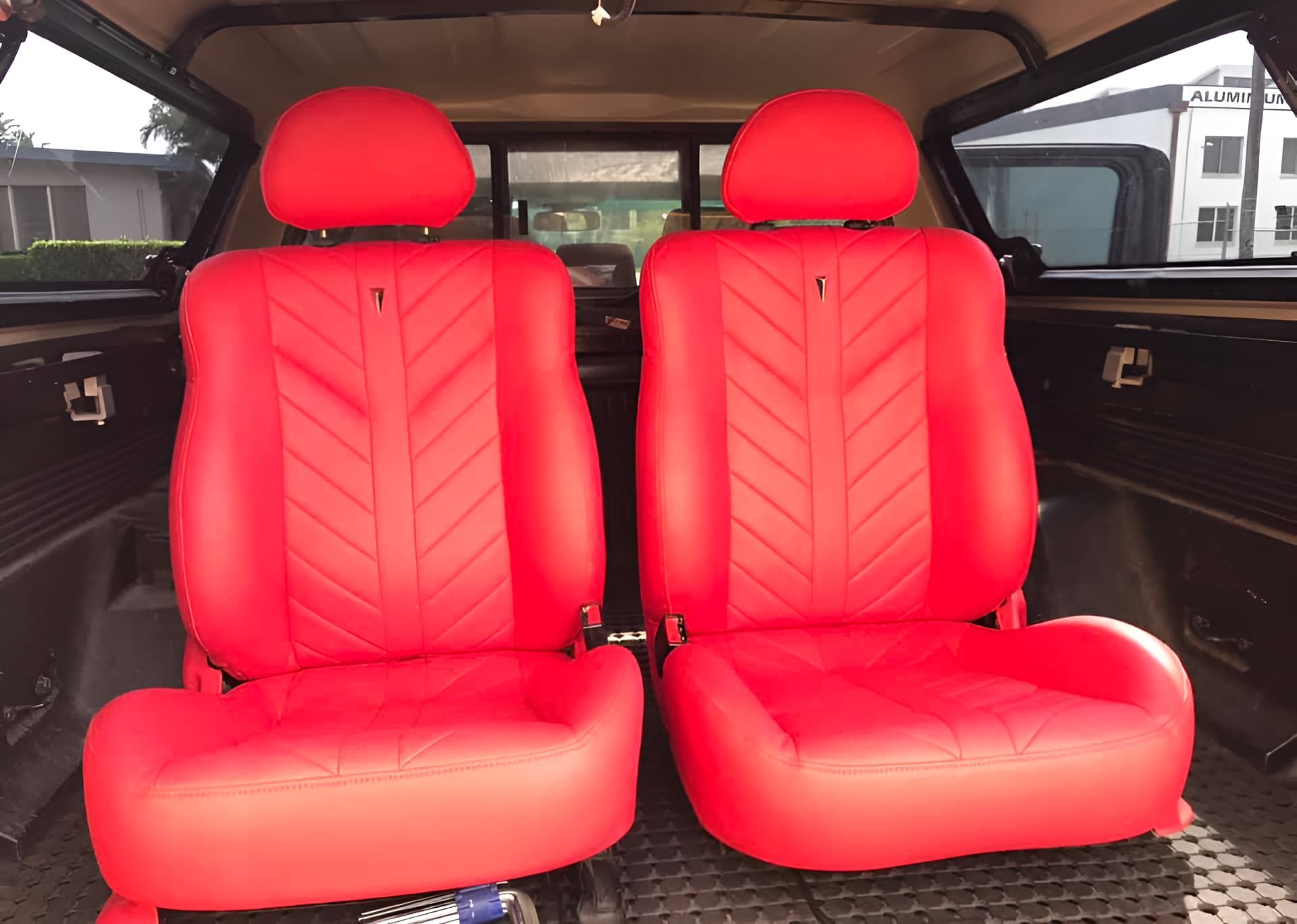 A Pair of Red Leather Seats in a Car — Currumbin Trimmers In Tweed Heads, NSW