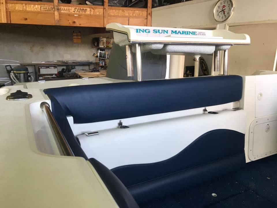 The Back of a Boat With a Blue Seat and a Clock on the Wall — Currumbin Trimmers In Tweed Heads, NSW