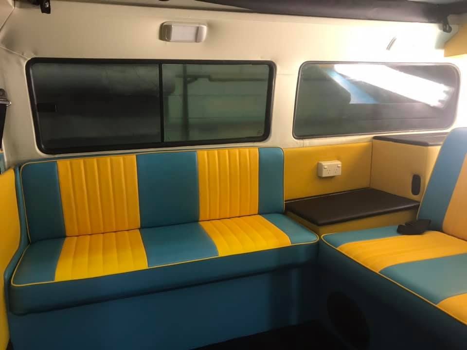 A Blue and Yellow Couch is in the Back of a Van — Currumbin Trimmers In Tweed Heads, NSW