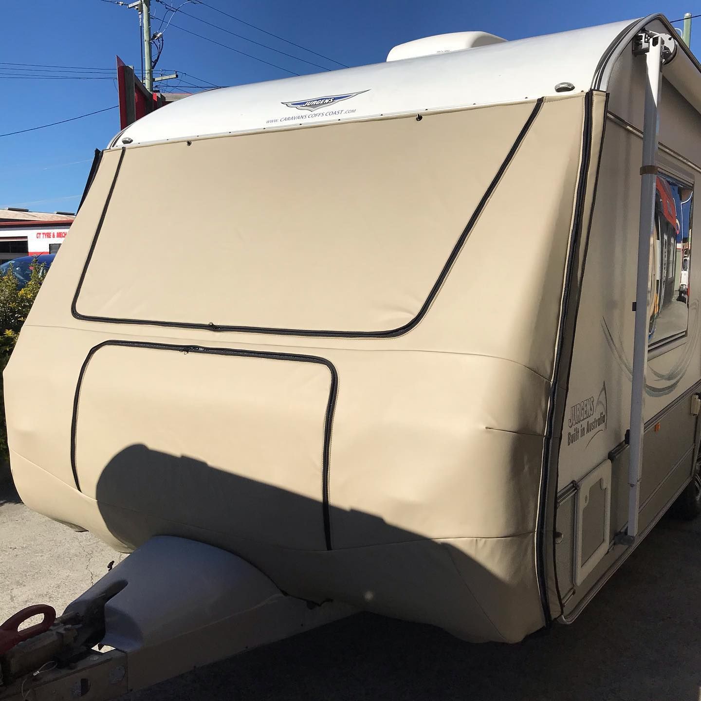 A Tan And White Trailer Is Parked On The Side Of The Road — Currumbin Trimmers In Currumbin Waters, QLD
