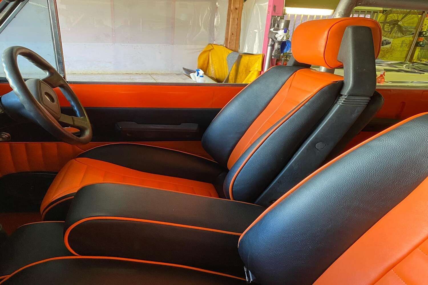 Black And Orange Seats In A Car With A Steering Wheel — Currumbin Trimmers  In Currumbin Waters, QLD