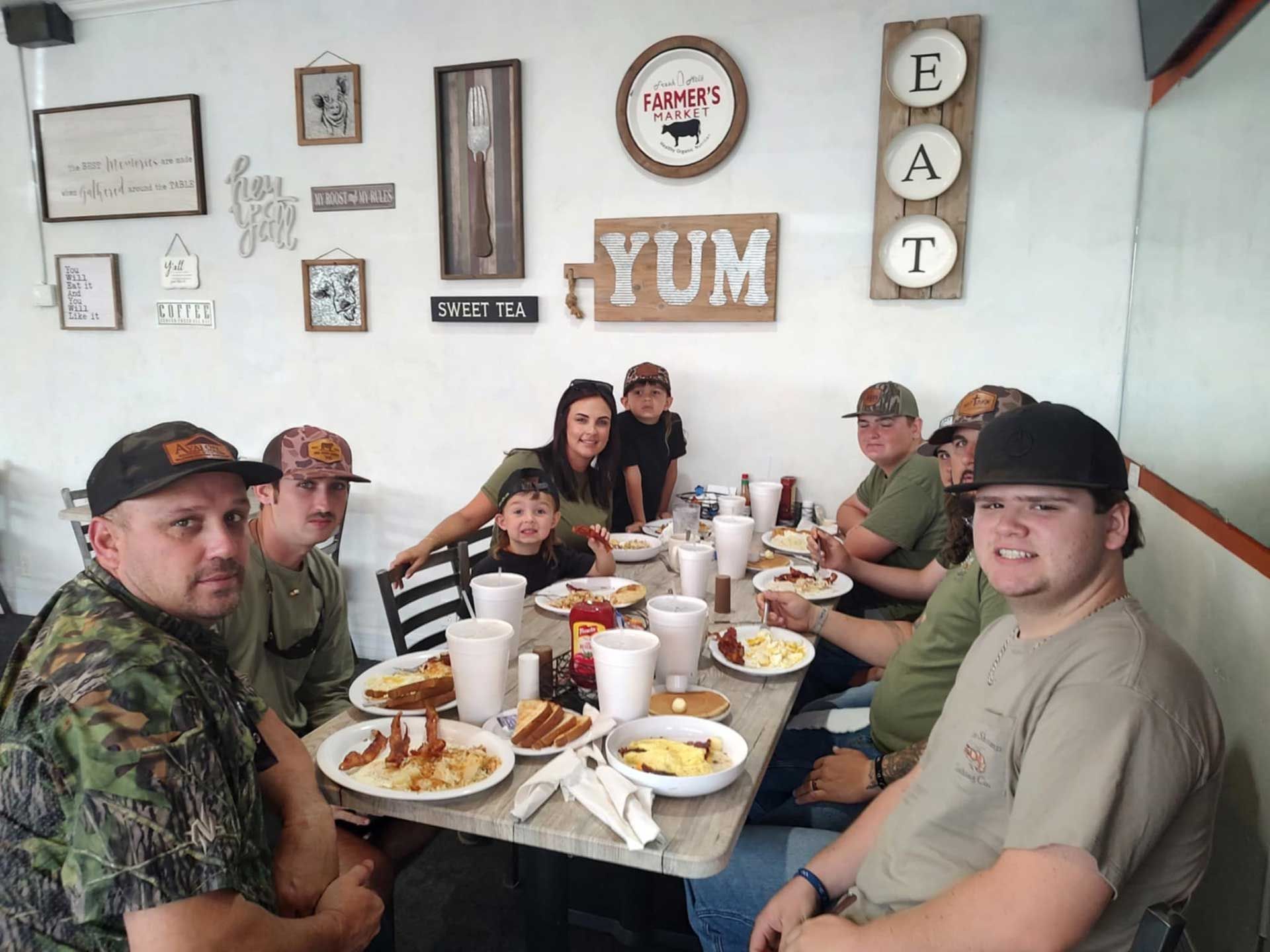 group of people around table eating 1