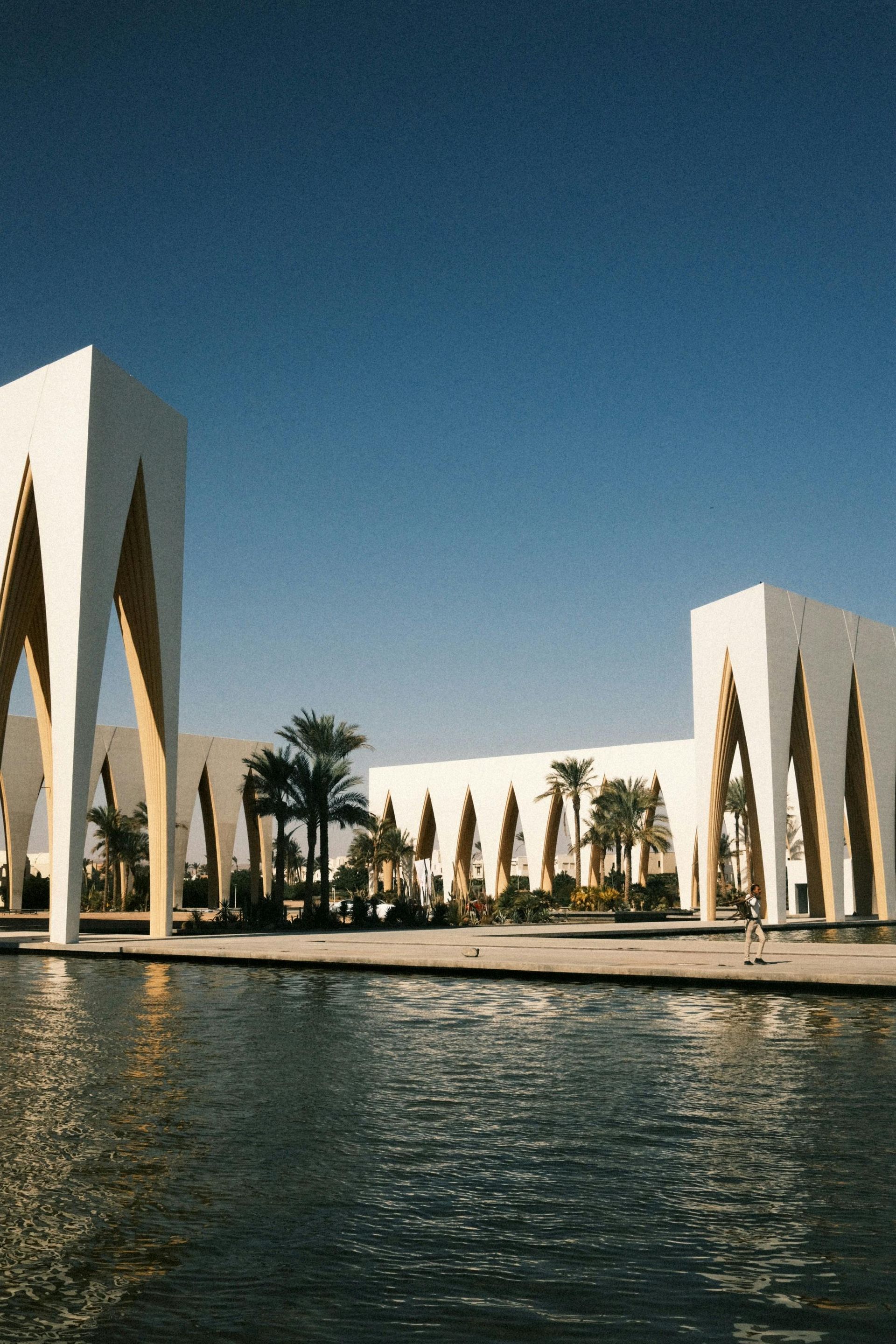 A large white building with palm trees in front of it