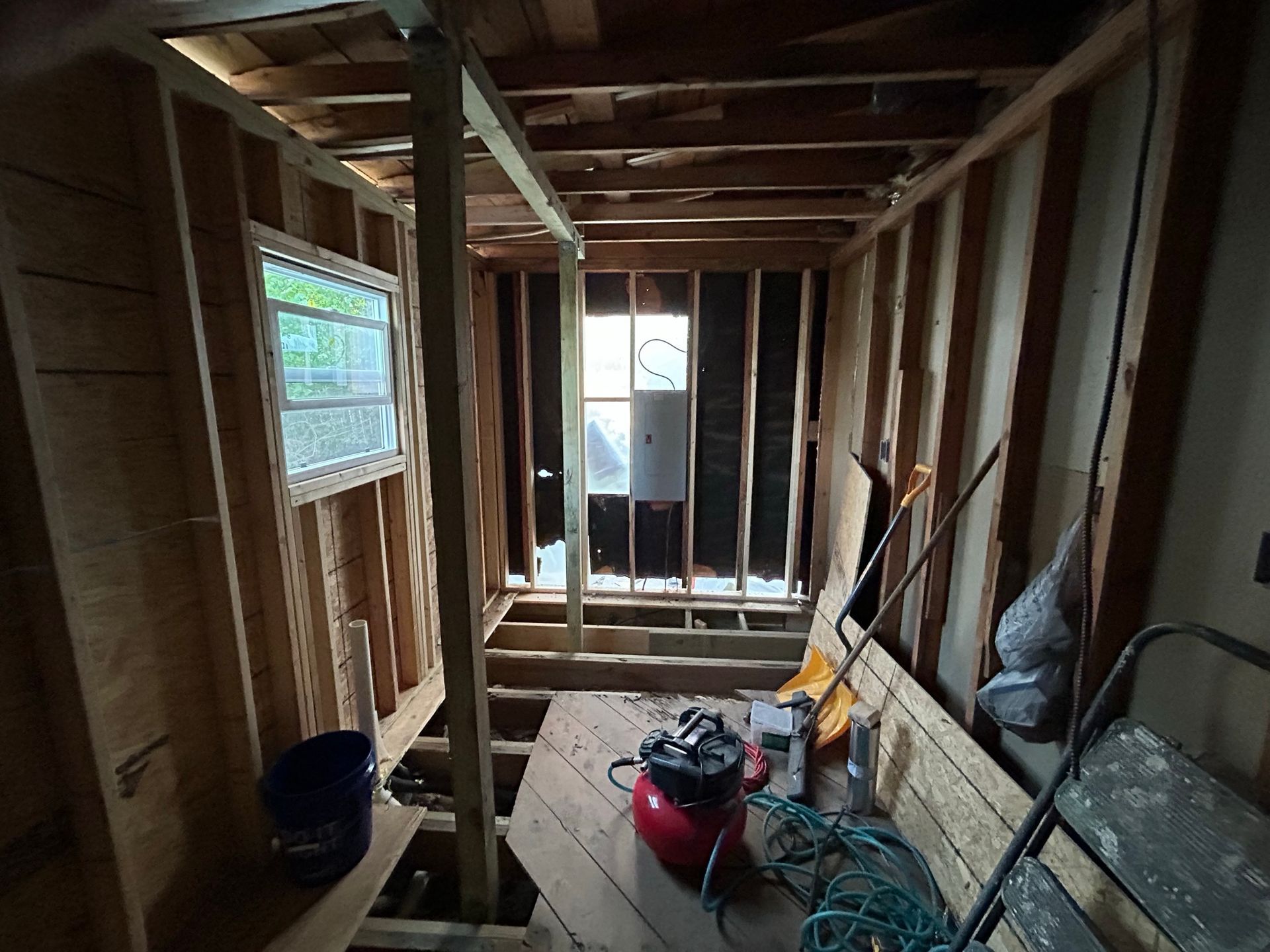 A room with a window and a vacuum cleaner in it.