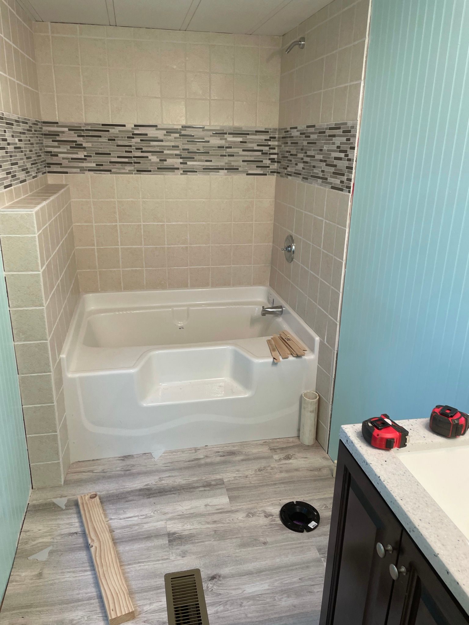 A bathroom with a bathtub and a sink.