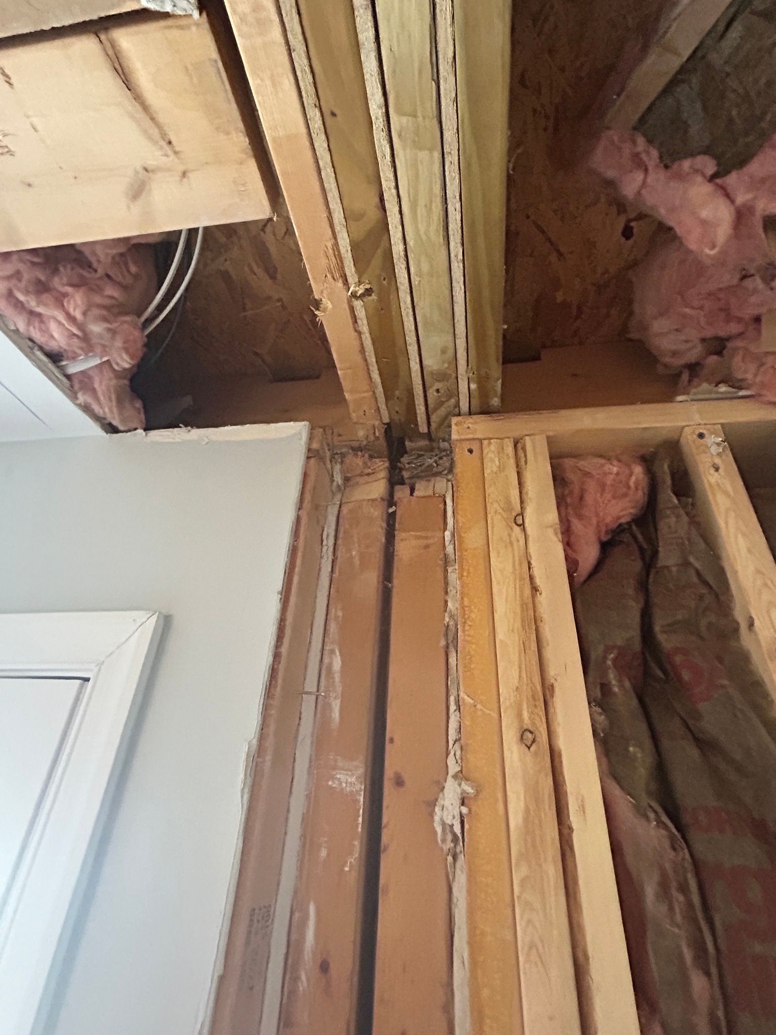 A room with a lot of wooden beams and insulation.