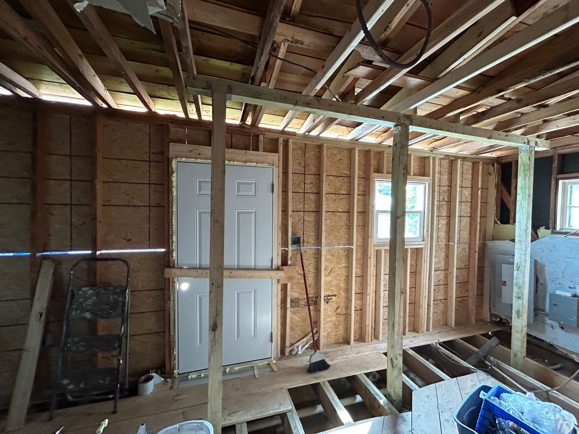 A room with a lot of wooden beams and doors.