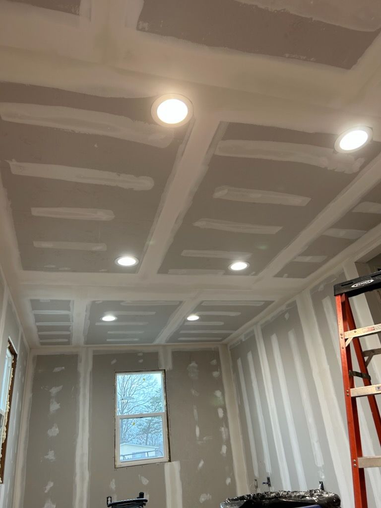 A room with a ladder and a window in it is being remodeled.